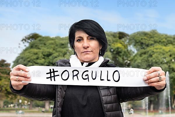 Woman holding an #orgullo or #pride sign. LGBT Concept