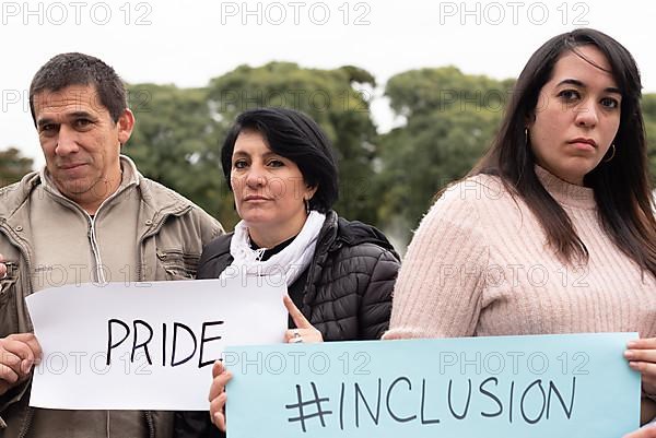 A group of people holding inclusion and pride signs as a protest. LGBT Concept