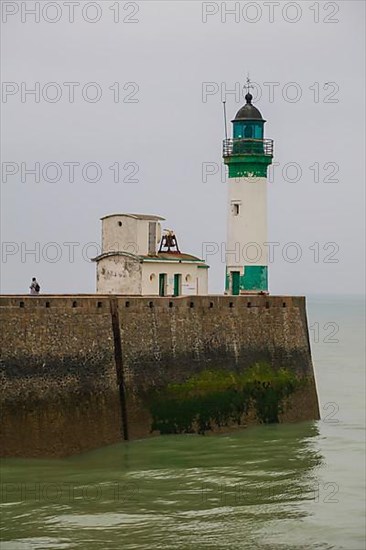 Top of the quay wall with lighthouse in the harbour of the coastal town of Le Treport at the mouth of the Bresle on the English Channel