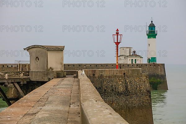 Top of the quay wall with lighthouse in the harbour of the coastal town of Le Treport at the mouth of the Bresle on the English Channel