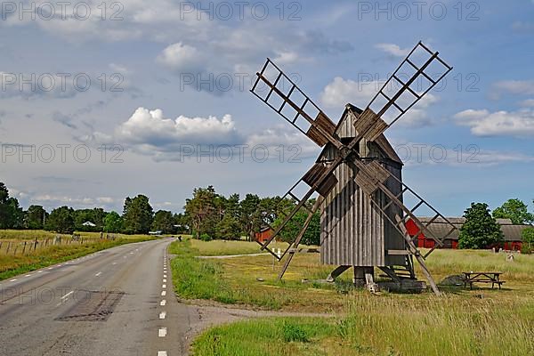 Old wooden mill standing by the road