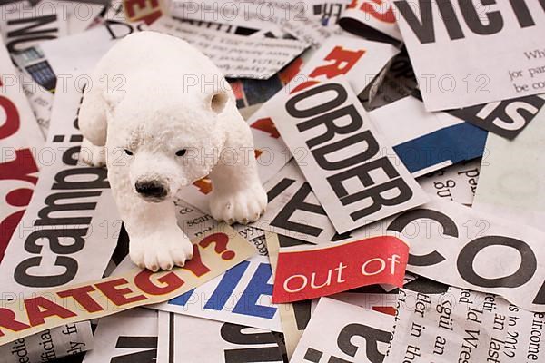 Polar bear on cut newspaper titles