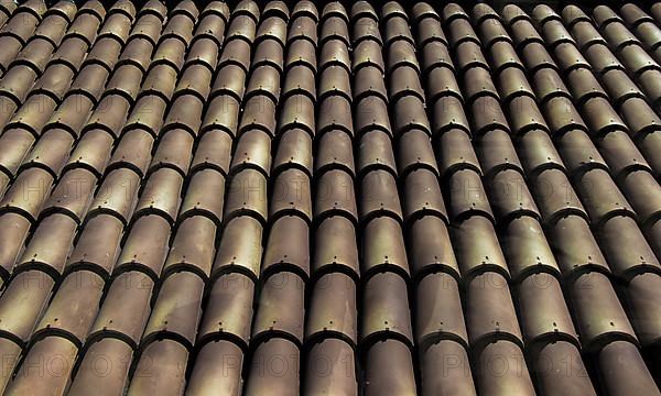 Background of old roof tiles made of colorful clay