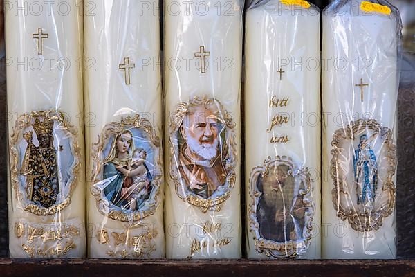 Candles with images of Mary and the saints in front of a devotional shop at Kapellplatz