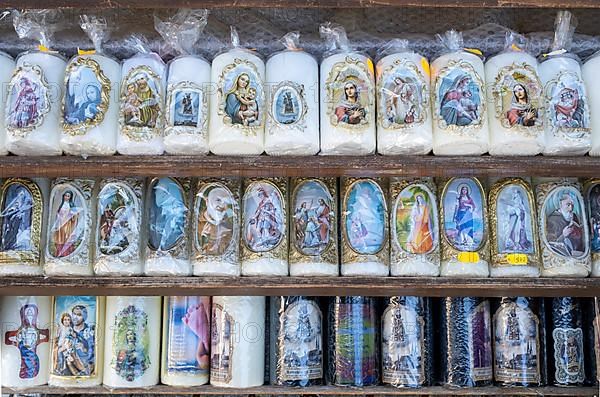 Candles with images of Mary and the saints in front of a devotional shop at Kapellplatz