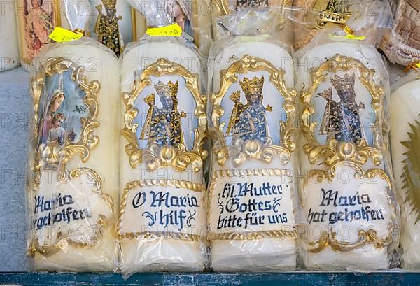 Candles with images of Mary and the Black Madonna in front of a devotional shop at Kapellplatz