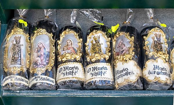 Candles with images of Mary and the Black Madonna in front of a devotional shop at Kapellplatz