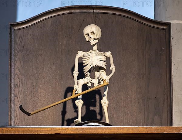 Rotating figure of the Death of Altoetting above a grandfather clock in the collegiate parish church of St. Philip and St. James