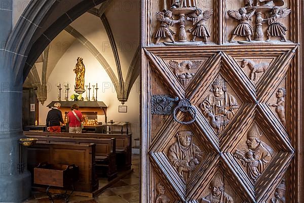 Richly decorated wooden portal with view into the collegiate parish church of St. Philip and St. James