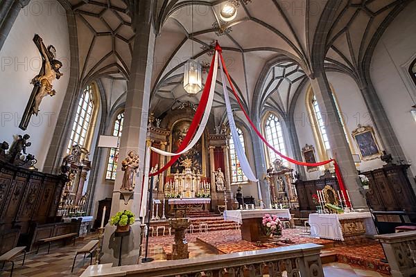 High altar of the collegiate parish church of St. Philip and St. James in the pilgrimage town of Altoetting. On the right