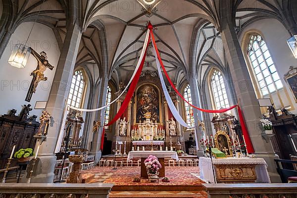 High altar of the collegiate parish church of St. Philip and St. James in the pilgrimage town of Altoetting. On the right