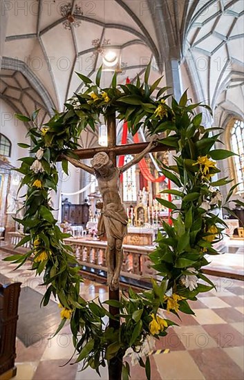 Crucifix framed with a floral wreath in the collegiate parish church of St. Philip and St. James