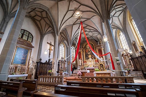 High altar of the collegiate parish church of St. Philip and St. James in the pilgrimage town of Altoetting. On the right