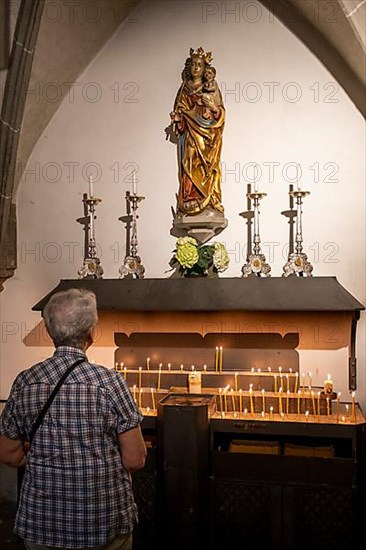 Image of the Virgin Mary over candles in the collegiate parish church of St. Philip and St. James