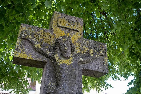 Weathered stone cross with Jesus figure
