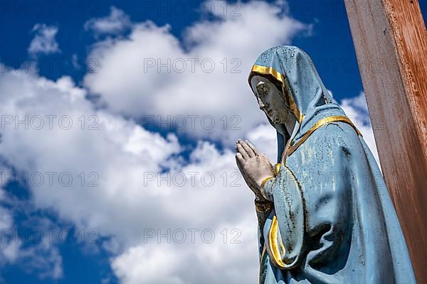 Figure of the Virgin Mary on a wooden cross in the St. Michael cemetery