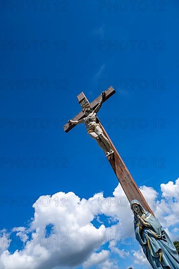 Figure of the Virgin Mary on a wooden cross with crucifix at the St. Michael cemetery