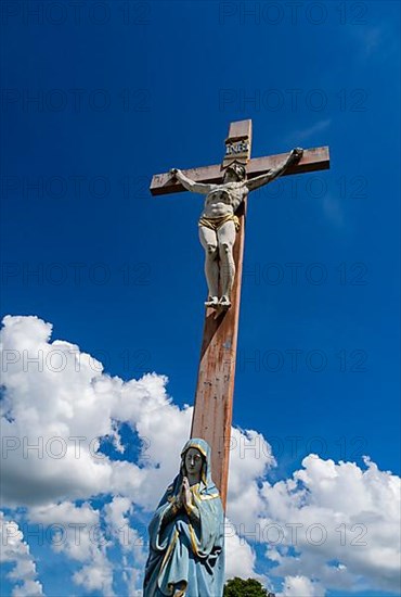 Figure of the Virgin Mary on a wooden cross with crucifix at the St. Michael cemetery