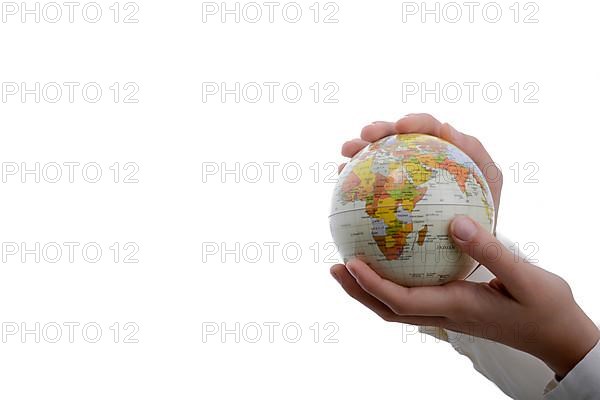 Child holding a small globe in hand on white background