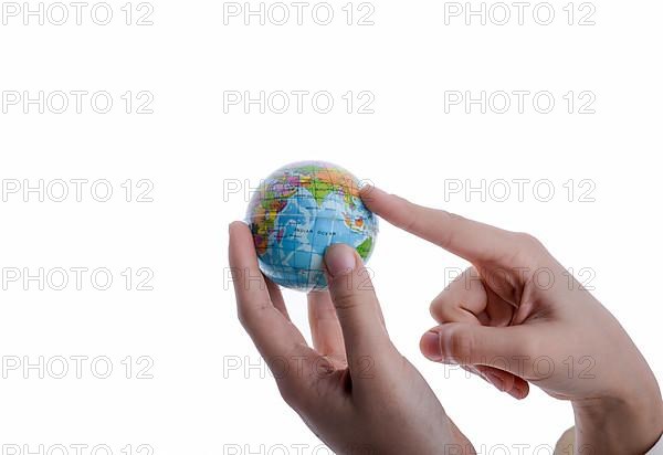 Child holding a small globe in hand on white background