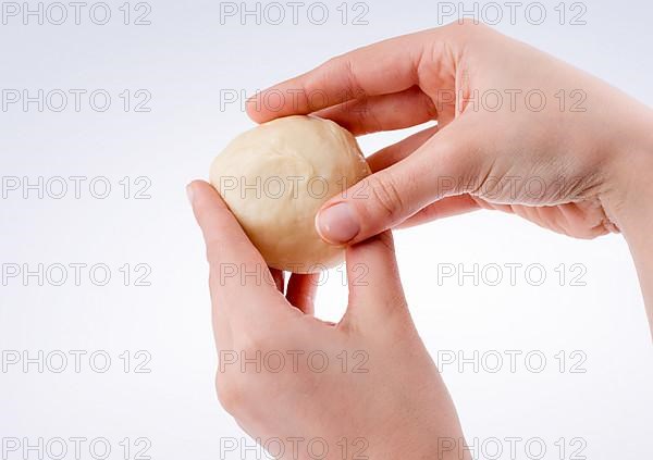 Hand holding paste on a white background