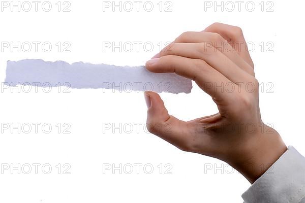 Hand holding a piece of blank torn notepaper