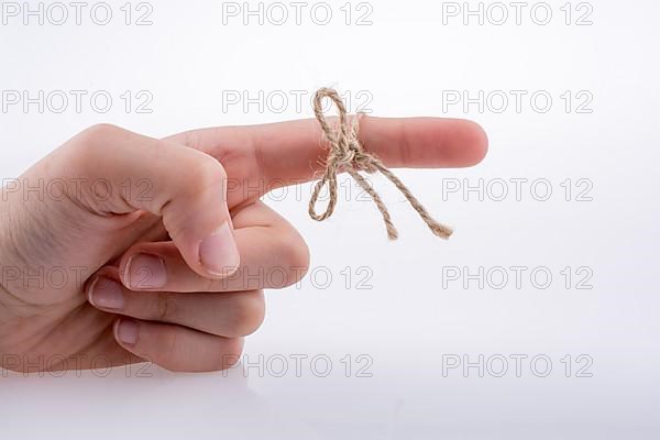 Hand tied with a thread like a ribbon on a white background