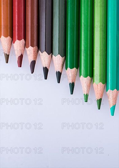 Color Pencils of Various colors placed on white background