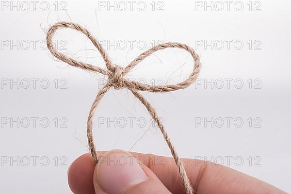 Thread knot in hand on a light color background