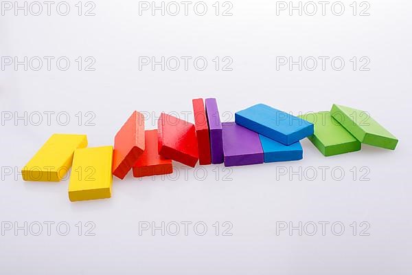 Colorful Domino Blocks in a line on a white background