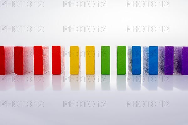 Colorful Domino Blocks in a line on a white background