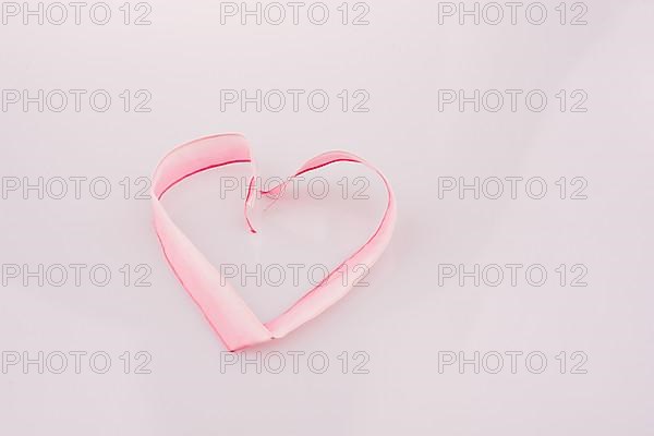 Heart made of ribbon on a white background