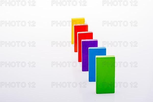 Colorful Domino Blocks in a line on a white background