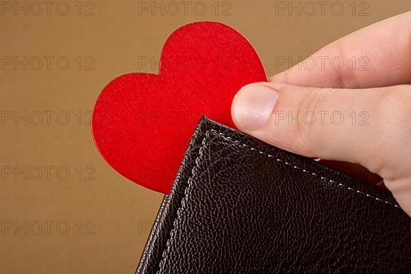 Brown leather wallet in hand saving and finance concept