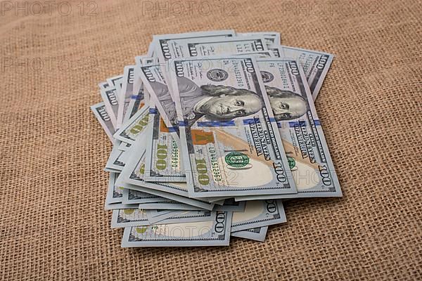 Banknote bundle of US dollar placed on a linen canvas
