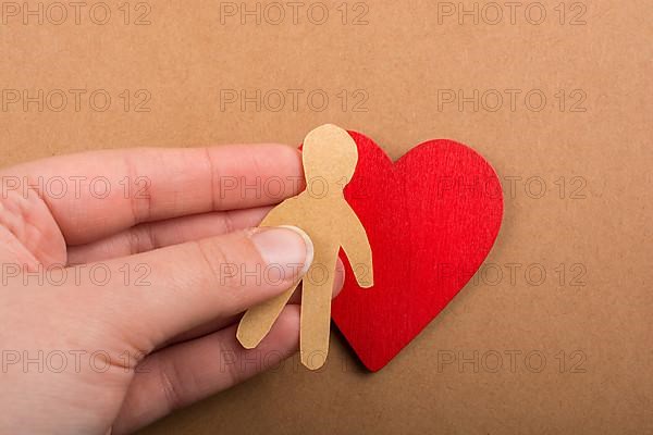 Man shape cut out of paper in hand in the view