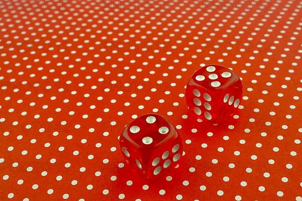 Red dice on a red background