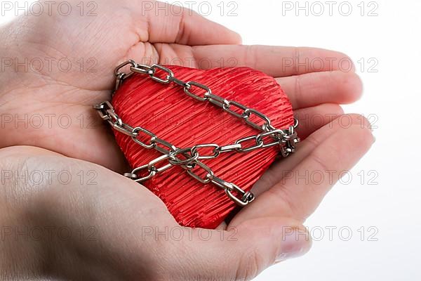 Red color heart shaped object in Chain on white background