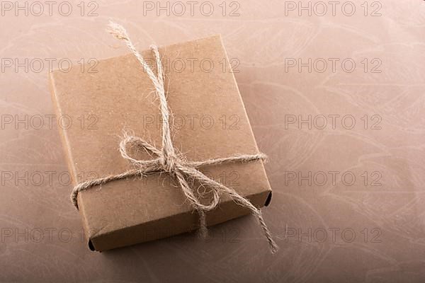 Gift box of a brown color and pine cone