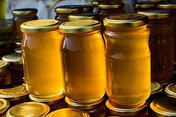 Glass jar of full of fresh honey with lid