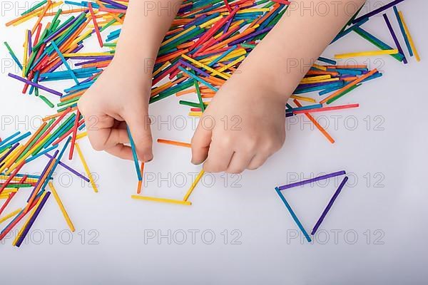 Kid making rectangular and triangle shape as creative concept