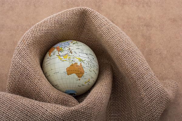 Linen canvas is wrapped around a model globe