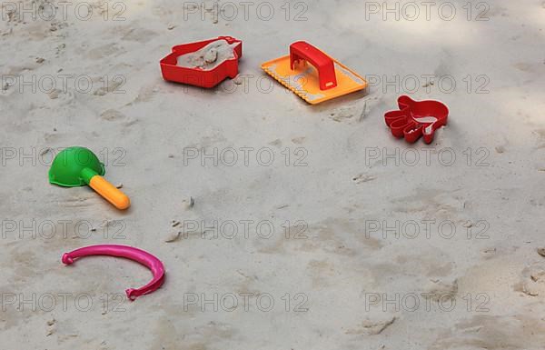 Colourful plastic children's toys in a sandbox