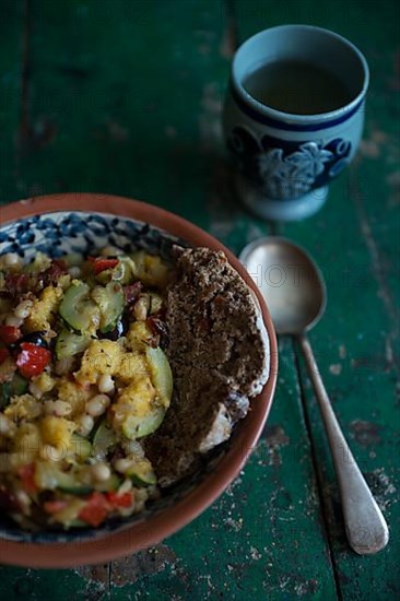 Vegan dish with a cup of wine on a rustic wooden table