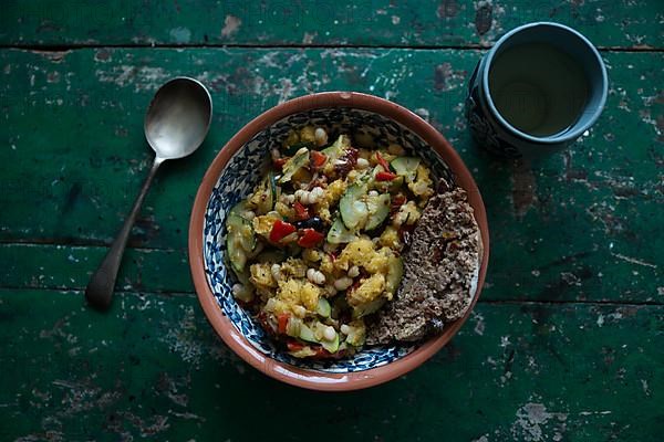 Vegan dish with a cup of wine on a rustic wooden table