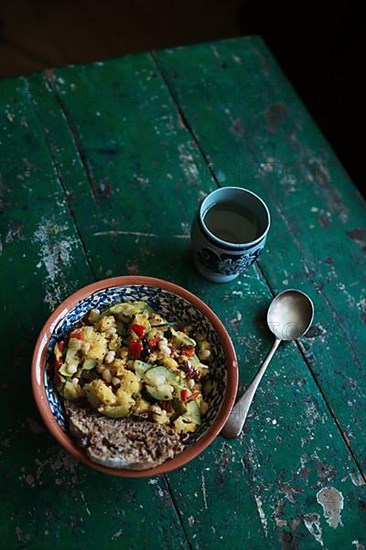 Vegan dish with a cup of wine on a rustic wooden table