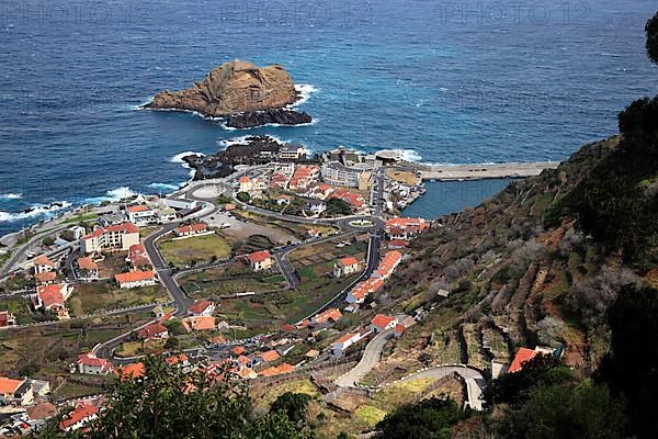 View of the village of Porto Moniz on the north-west coast of the island small offshore island Ilheu Mole