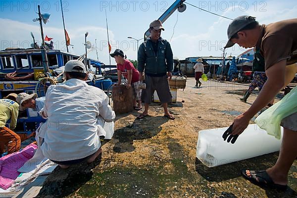 Small fishing pier on the Thu Bon River where a fishing boat is unloaded