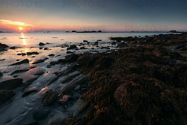 Rocks on the beach of Port Blanc in the evening light