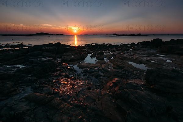 Rocks on the beach of Port Blanc in the evening light